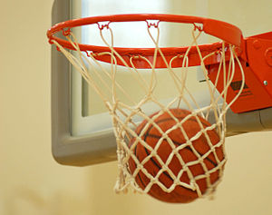 English: A basketball falls through the hoop